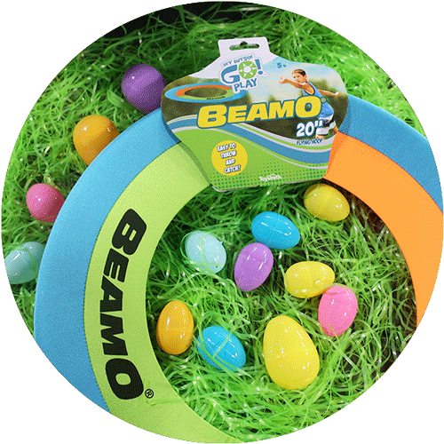 A blue, green and orange large hoop frisbee, surrounded by green easter grass and colorful easter eggs.